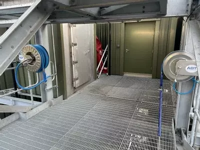 Two stainless steel hose reels installed on an elevated platform as part of the multi-point washdown system at an industrial site in Burton.